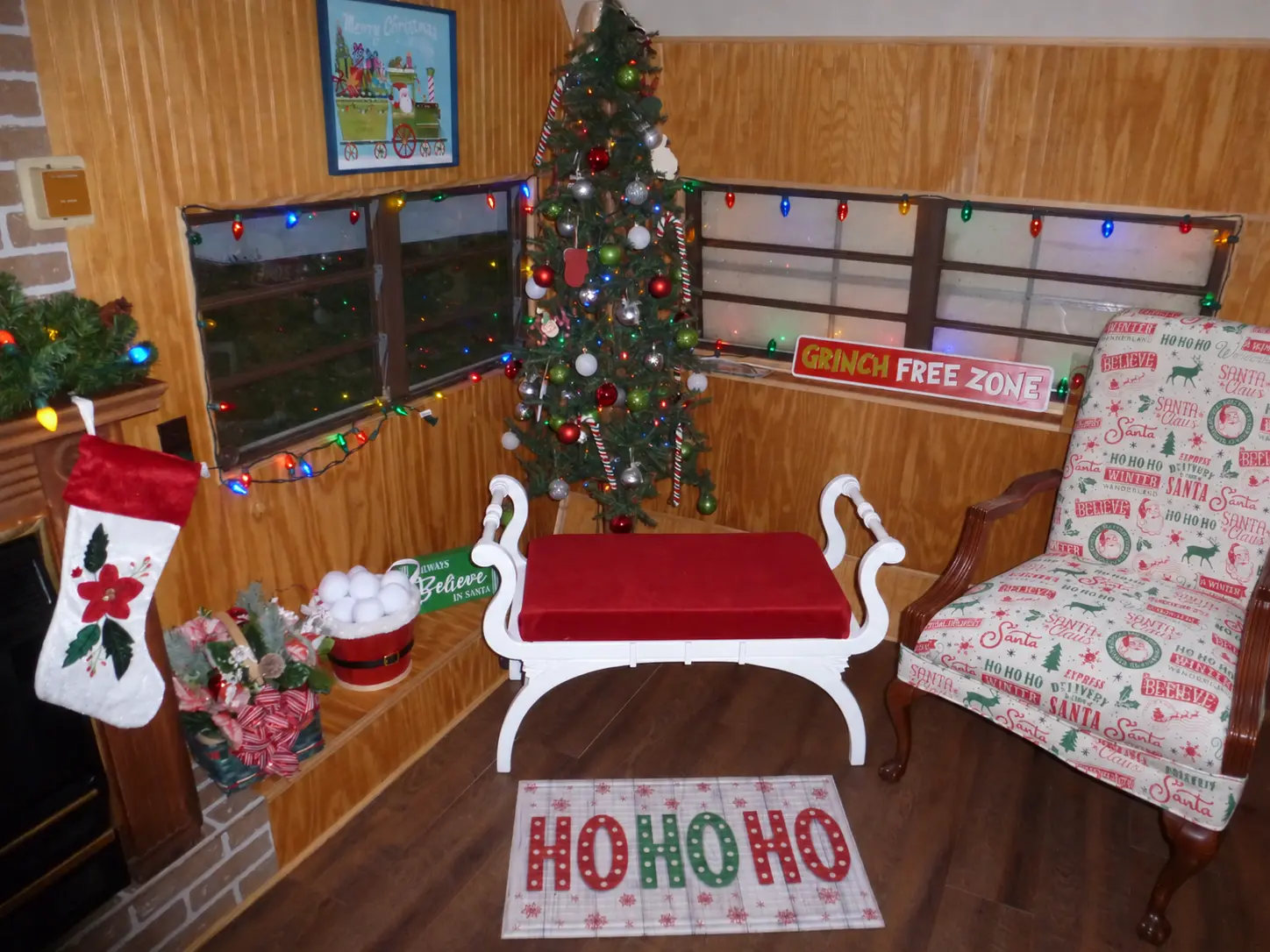 Santa's chair beside the photo bench and decorated Christmas tree