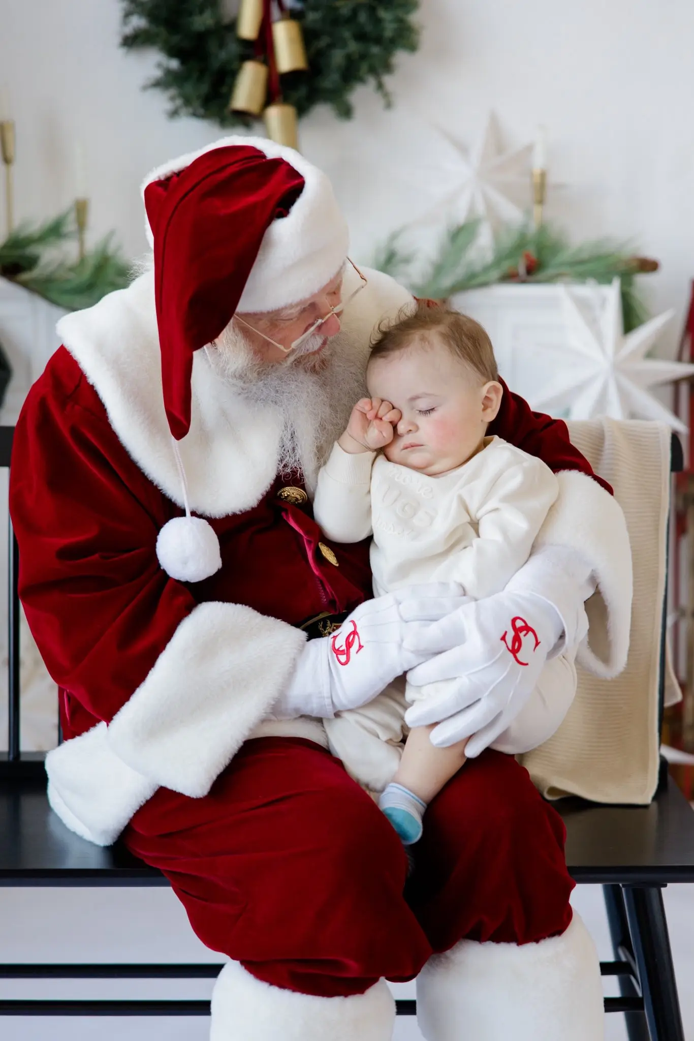 Santa Skip comforting a sleepy baby during a visit