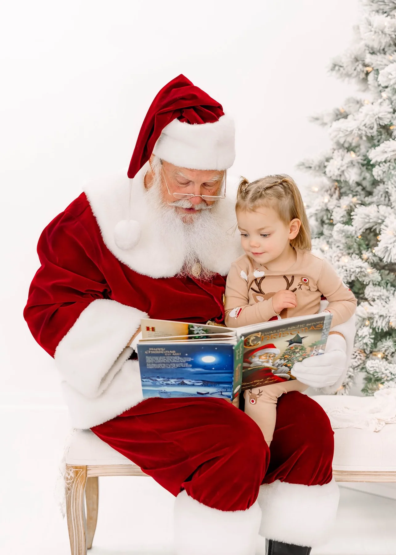 Santa Skip reading a Christmas book with a child