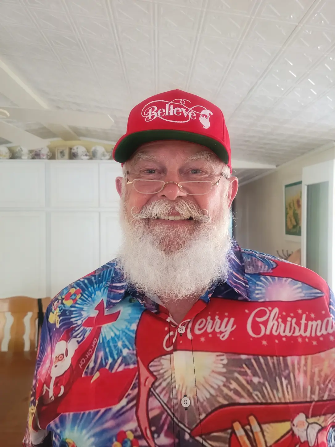 Santa Skip in a colorful casual Christmas shirt and red cap