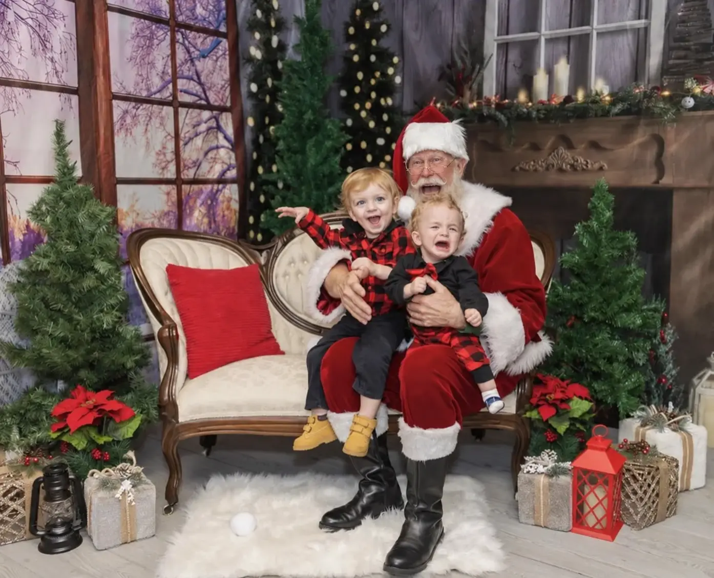 Santa Skip smiling with two children at a Christmas gathering
