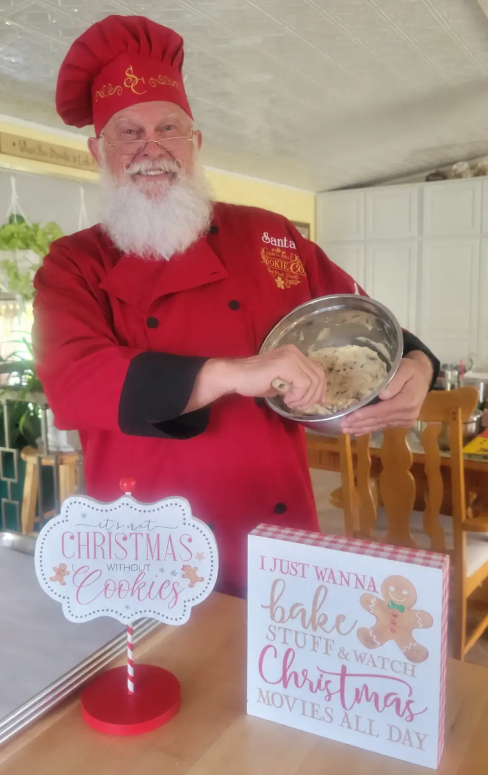 Santa Skip in a red chef outfit at a Christmas baking display