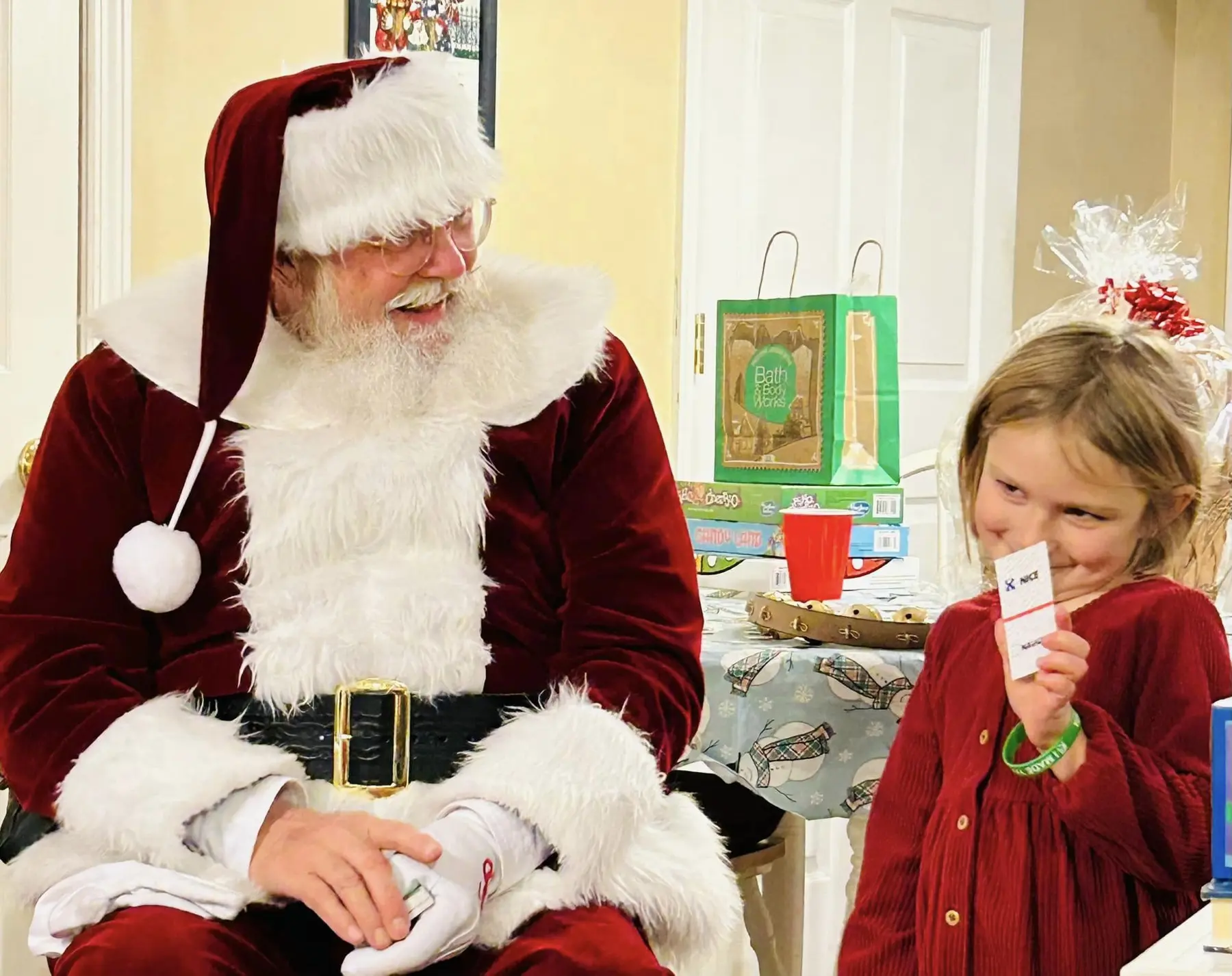 Santa Skip sharing a playful personal moment with a young girl